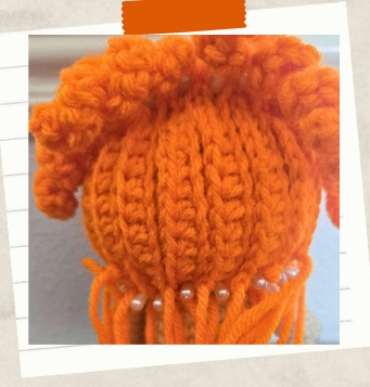 Free witch crochet pattern with curly orange hair.