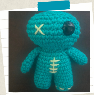 easy crochet keychain for beginners showing decorative stitches embroidered into the body.