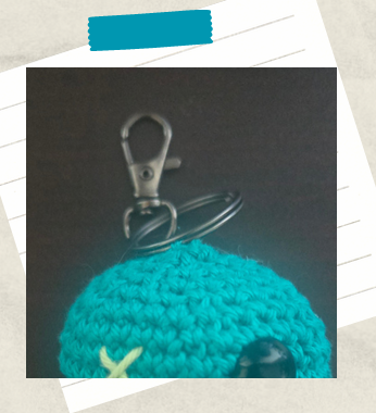 a photo showing an easy clipping of key chain hardware to a crochet keychain