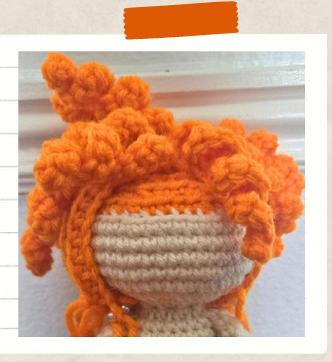 Witch crochet pattern with curly orange hair.