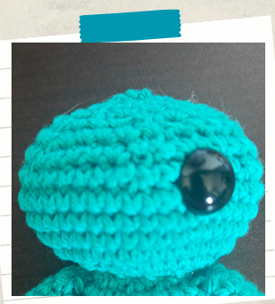 Crochet keychain tutorial showing how to make the head of a mini amigurumi doll.