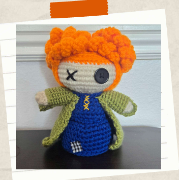 Whimsical crochet witch doll for spooky season decor.