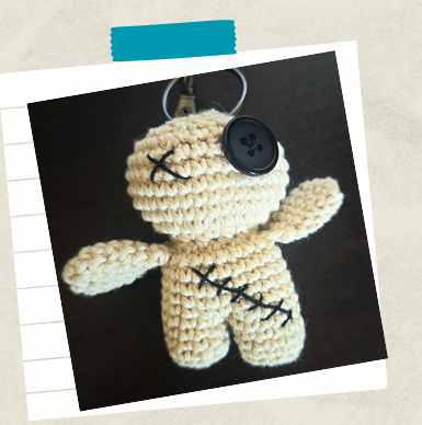Easy crochet keychain for beginners displayed as a purse charm made with scrap yarn.