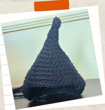 Black yarn hair details for handmade crochet witch doll.