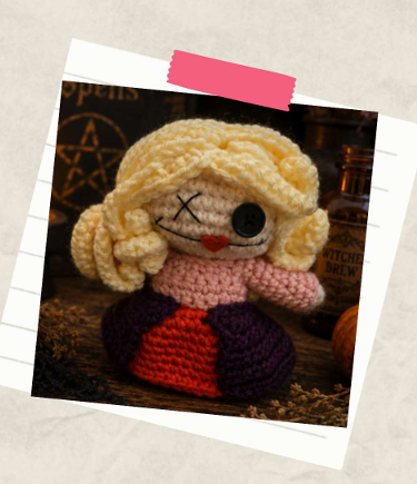 Handmade Halloween amigurumi witch doll with long blonde yarn hair and colorful crochet dress