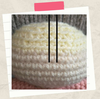 Close-up of the handmade blonde yarn hair on a crochet Halloween amigurumi witch doll
