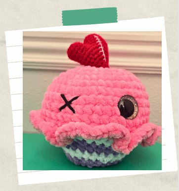 A completed plushy crochet cupcake.