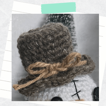 A close up photo of a completed crochet top hat for a crochet snowman amigurumi.