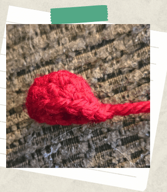 A tutorial picture showing the beginning of a heart top to create a crochet heart.