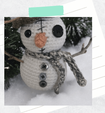 A tutorial photo showing a close up of a scarf wrapped around a snowman crochet pattern.