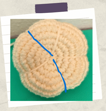 a tutorial picture showing how to sculpt a garlic crochet clove