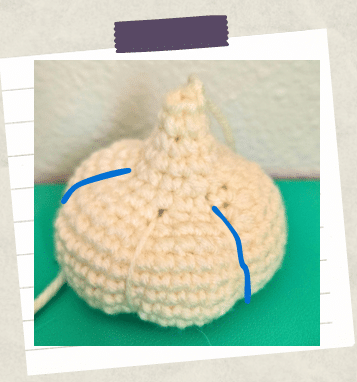 a tutorial picture showing how to sculpt a garlic crochet clove into shape